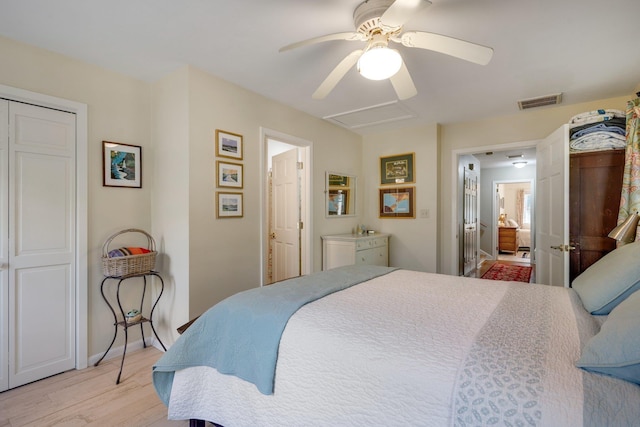 bedroom featuring connected bathroom, light hardwood / wood-style flooring, and ceiling fan