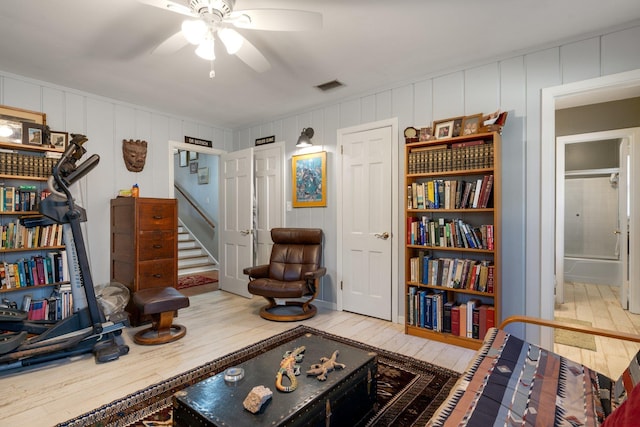 living room with hardwood / wood-style floors and ceiling fan