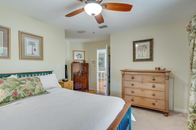 bedroom with ceiling fan and light colored carpet