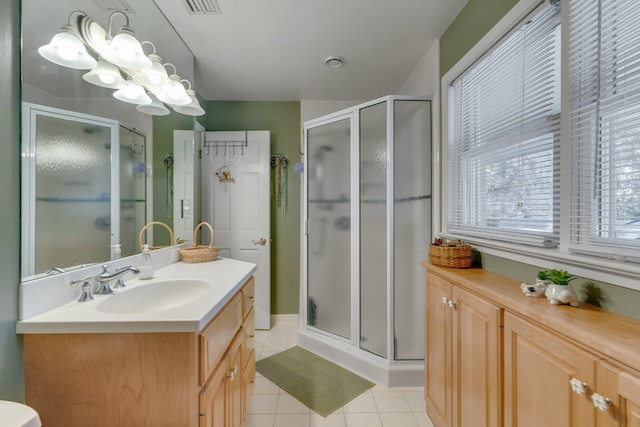 bathroom featuring vanity, an enclosed shower, and tile patterned flooring