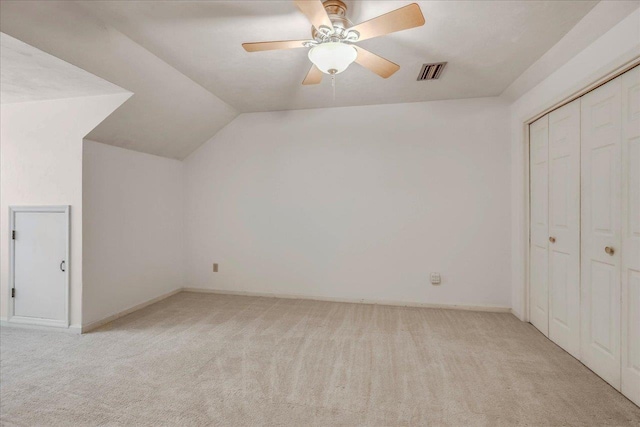 bonus room featuring a ceiling fan, visible vents, vaulted ceiling, and light carpet