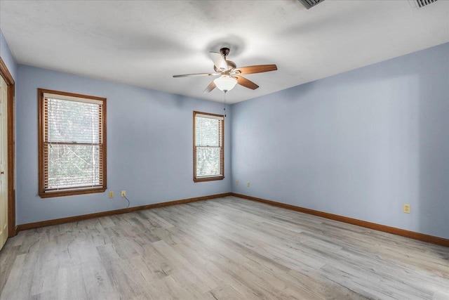 unfurnished room featuring ceiling fan, light wood-style flooring, and baseboards