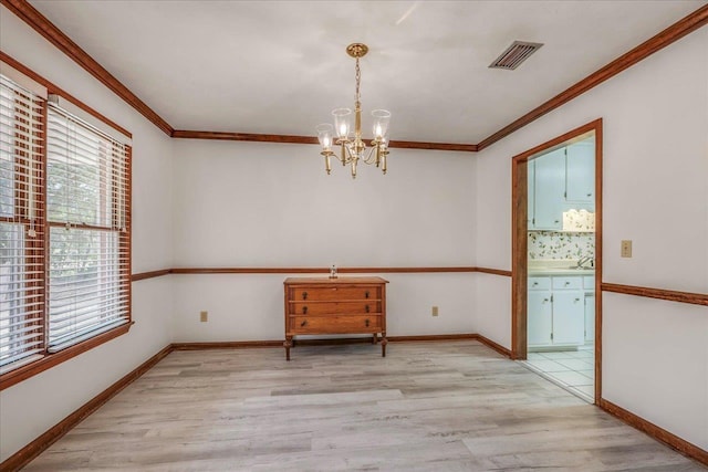 unfurnished dining area featuring light wood-style floors, visible vents, and crown molding