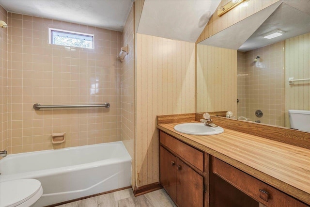 full bathroom with  shower combination, vanity, toilet, and wood finished floors