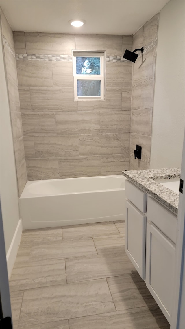 bathroom featuring vanity and tiled shower / bath combo