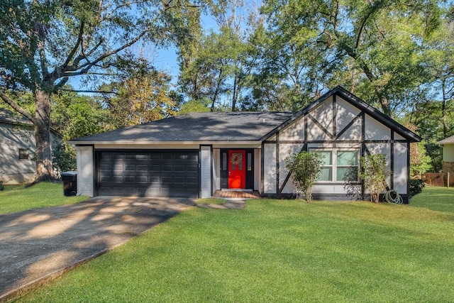 view of front of property with a front yard and a garage