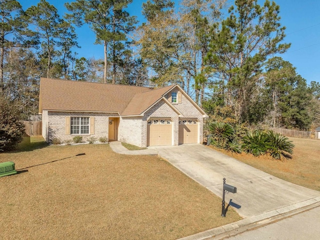 view of front of house featuring a garage and a front lawn