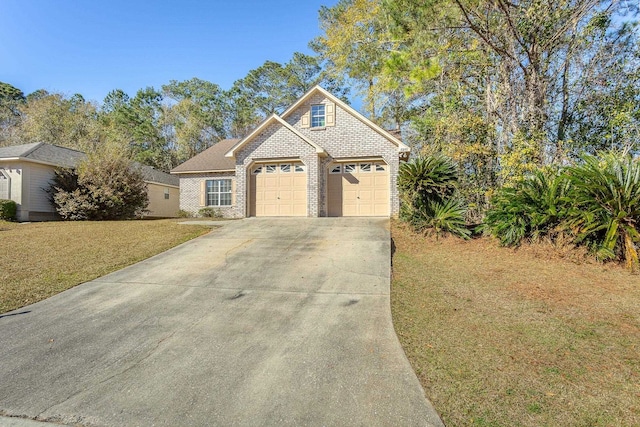 view of front of home with a garage and a front lawn