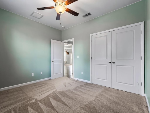 unfurnished bedroom featuring visible vents, a closet, carpet flooring, and baseboards