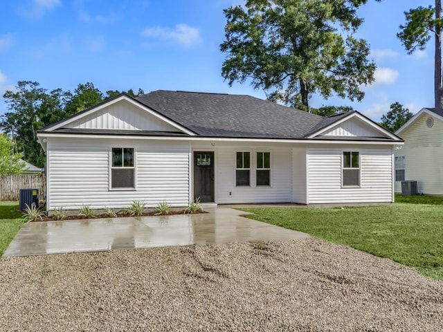 ranch-style house featuring a patio, roof with shingles, and a front yard