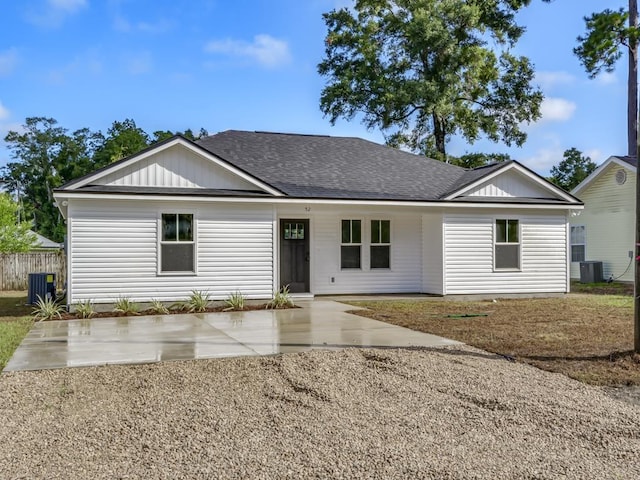 ranch-style home featuring roof with shingles and cooling unit