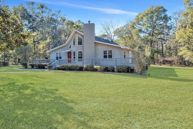 view of side of property with a wooden deck and a yard