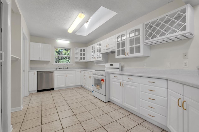 kitchen featuring stainless steel dishwasher, sink, white electric range oven, a skylight, and white cabinets