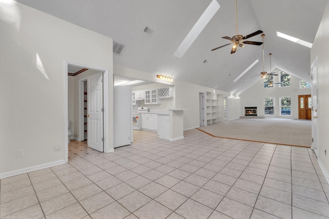 unfurnished living room featuring ceiling fan, high vaulted ceiling, and light tile patterned flooring