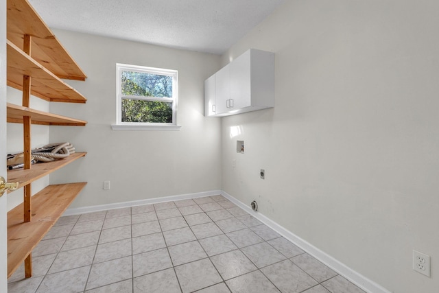 clothes washing area featuring cabinets, washer hookup, light tile patterned floors, and hookup for an electric dryer