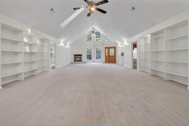 unfurnished living room with ceiling fan, built in features, light colored carpet, and high vaulted ceiling