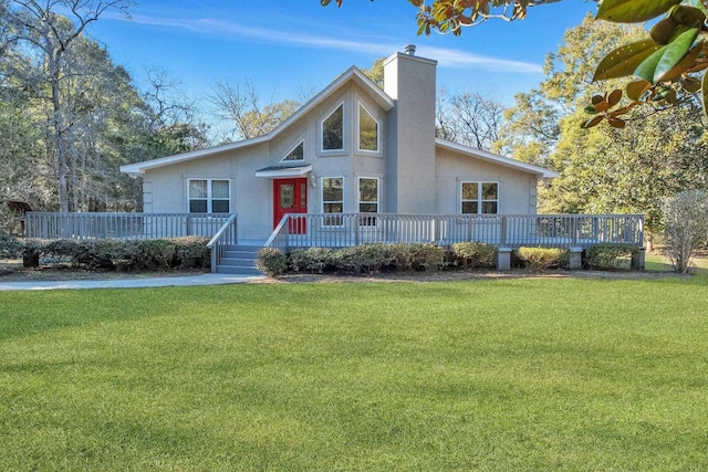 view of front of property with a deck and a front lawn