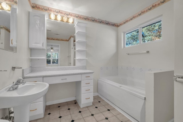 bathroom with ceiling fan, a washtub, and sink