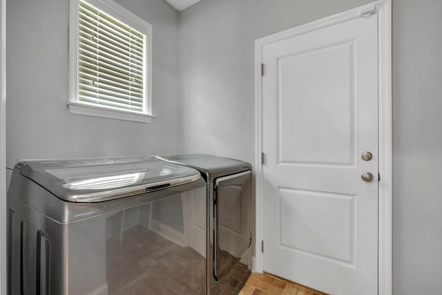 3260 Coneflower Dr, Tallahassee, FL 32311 - laundry room with washer and clothes dryer, light wood finished floors, and baseboards