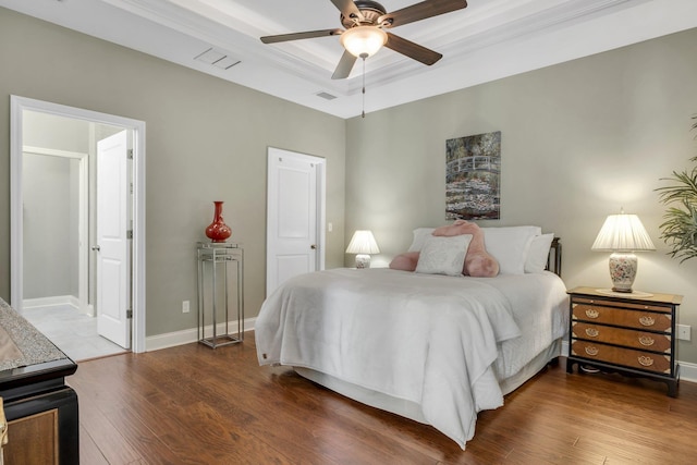 3260 Coneflower Dr, Tallahassee, FL 32311 - bedroom featuring a tray ceiling, dark wood finished floors, a ceiling fan, and baseboards