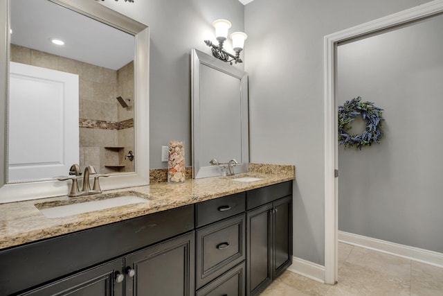 3260 Coneflower Dr, Tallahassee, FL 32311 - full bath featuring double vanity, baseboards, tiled shower, and tile patterned flooring