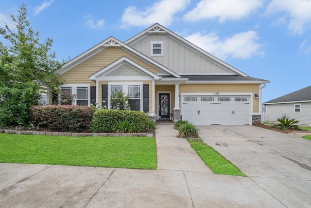 3260 Coneflower Dr, Tallahassee, FL 32311 - craftsman house with board and batten siding, concrete driveway, an attached garage, a front lawn, and stone siding