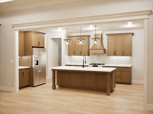 kitchen featuring tasteful backsplash, premium range hood, pendant lighting, sink, and stainless steel fridge with ice dispenser