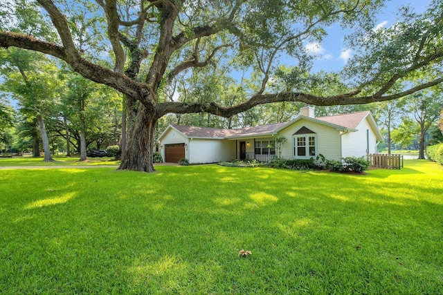6557 Alan A Dale Trl, Leon, FL 32309 - ranch-style house with an attached garage, a front lawn, and a chimney