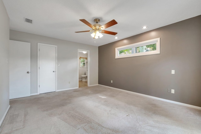 6557 Alan A Dale Trl, Leon, FL 32309 - unfurnished bedroom with ensuite bath, baseboards, carpet flooring, recessed lighting, and ceiling fan