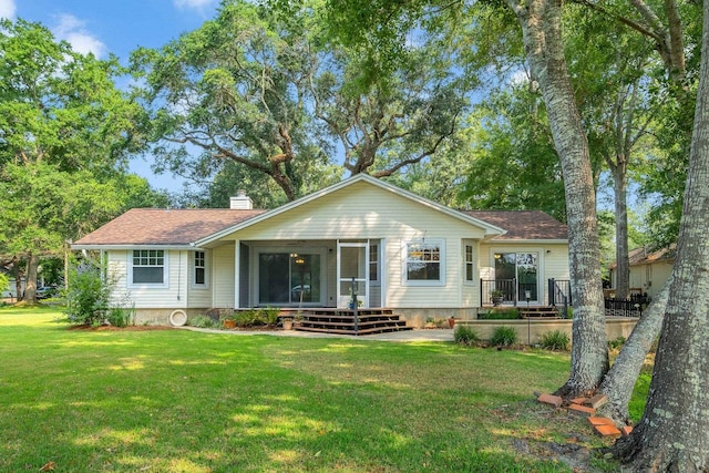 6557 Alan A Dale Trl, Leon, FL 32309 - view of front of house featuring a sunroom, a chimney, a front lawn, and roof with shingles