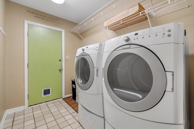 6557 Alan A Dale Trl, Leon, FL 32309 - washroom with washing machine and dryer, baseboards, and light tile patterned floors