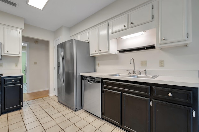 6557 Alan A Dale Trl, Leon, FL 32309 - kitchen with stainless steel appliances, a sink, white cabinetry, light countertops, and light tile patterned floors