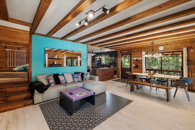 436 Tharpe Cir, Quincy, FL 32351 - living area with wooden walls, wood finished floors, beamed ceiling, and a chandelier