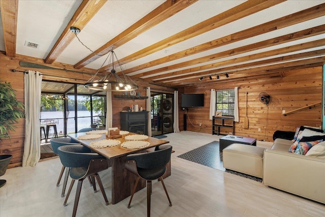 436 Tharpe Cir, Quincy, FL 32351 - dining space with wood walls, a chandelier, and beam ceiling