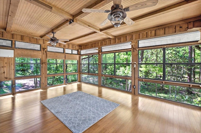 sunroom / solarium with beamed ceiling, a ceiling fan, hardwood / wood-style floors, and wood ceiling