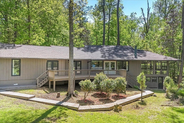 rear view of house with crawl space, roof with shingles, a deck, and stairs