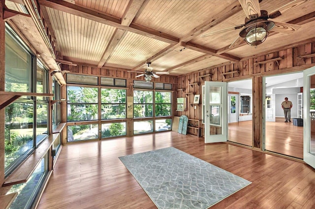 sunroom / solarium with wood ceiling, wood walls, beam ceiling, and hardwood / wood-style flooring