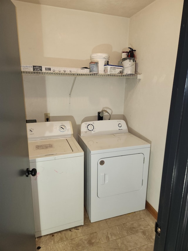 clothes washing area featuring washer and clothes dryer