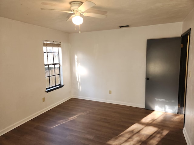 unfurnished room with dark hardwood / wood-style flooring and ceiling fan