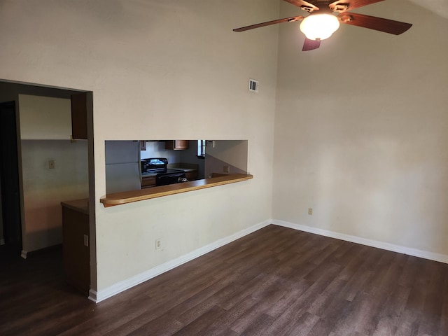 unfurnished living room featuring ceiling fan and dark hardwood / wood-style flooring