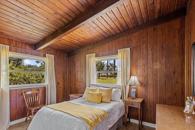 bedroom with hardwood / wood-style flooring, wood walls, and beamed ceiling