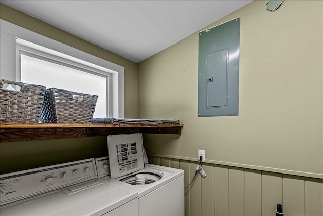 washroom with electric panel, a wealth of natural light, and washing machine and dryer