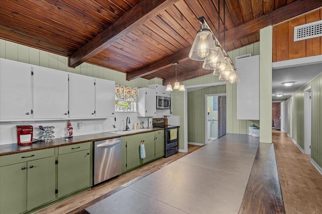 kitchen with pendant lighting, sink, beamed ceiling, white cabinetry, and stainless steel appliances