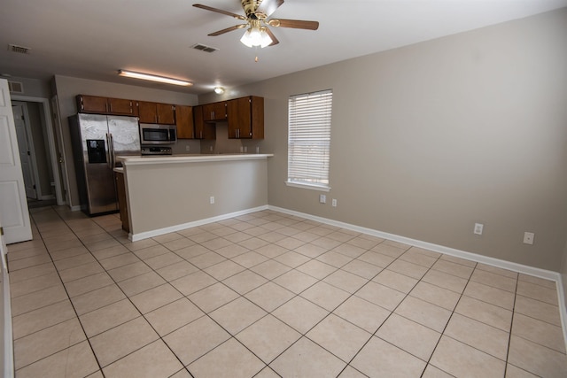 kitchen featuring stainless steel appliances, kitchen peninsula, and ceiling fan