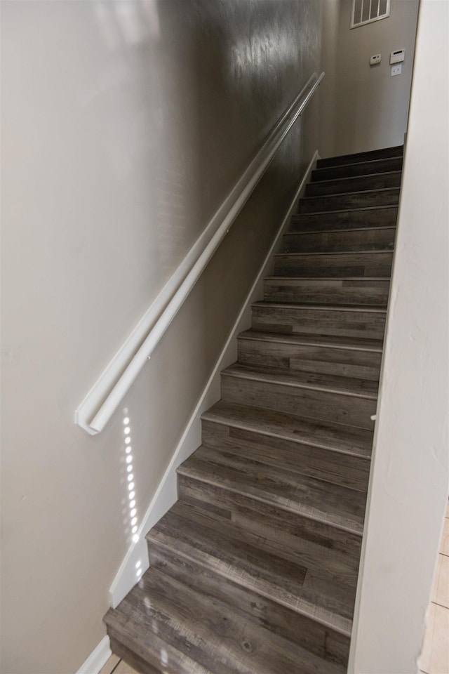 stairs with wood-type flooring