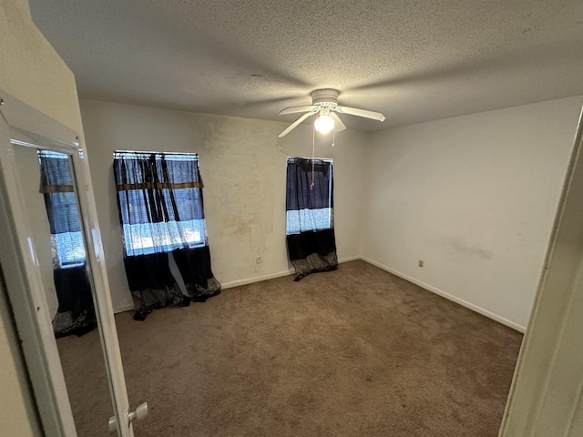 unfurnished bedroom with carpet flooring, a textured ceiling, and ceiling fan