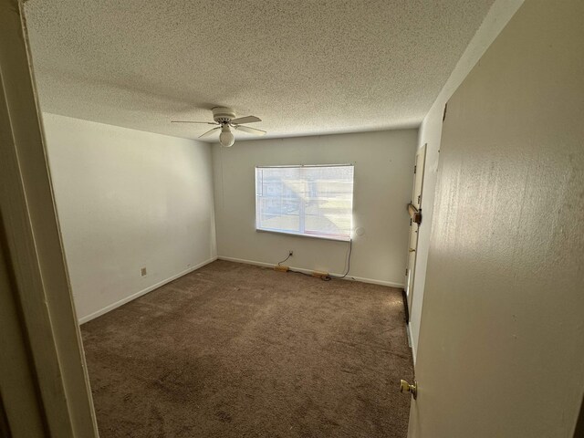 unfurnished room with ceiling fan, carpet floors, and a textured ceiling