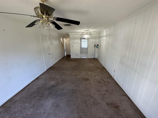 empty room with dark carpet and a textured ceiling