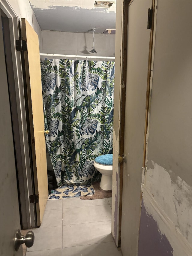 bathroom with tile patterned floors and toilet