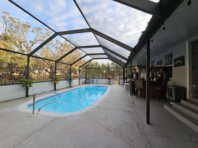 view of pool with a patio area, a lanai, and exterior bar